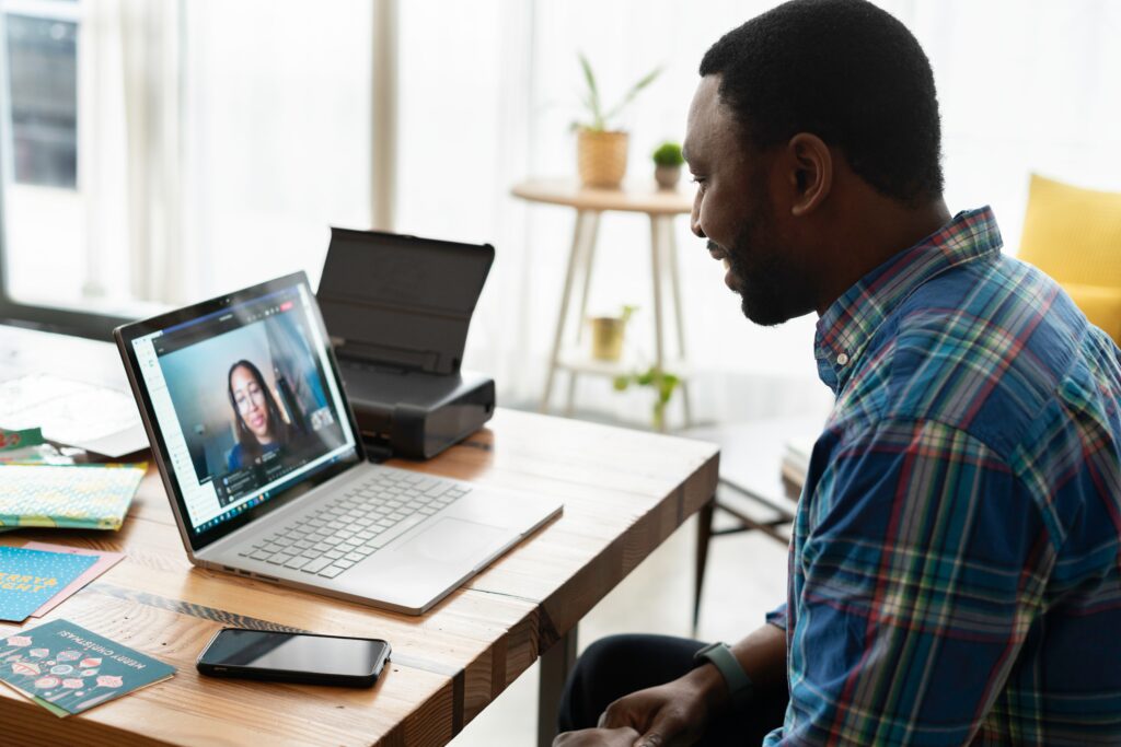 A man on a zoom call with a lady