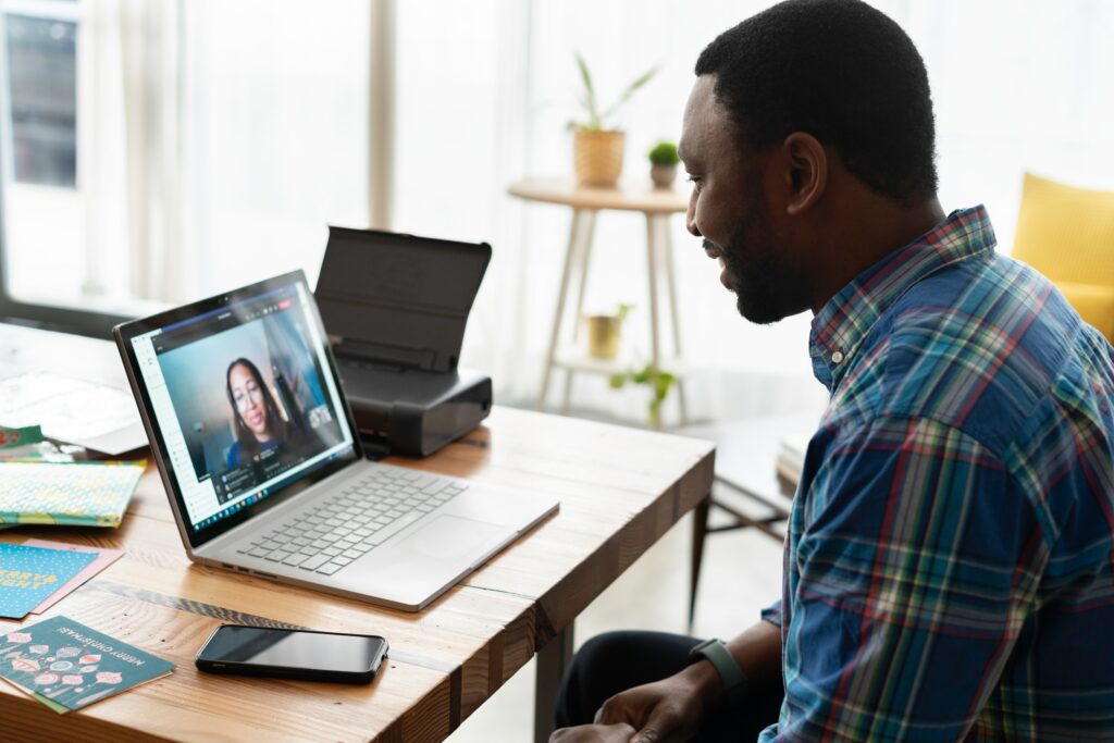 A man on a zoom call with a lady 