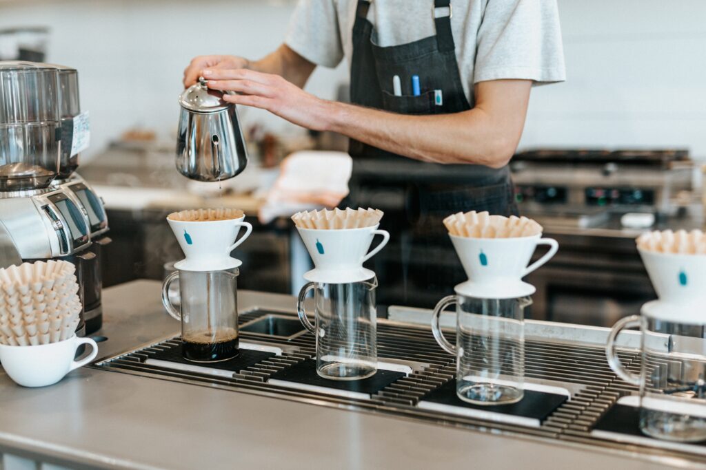 A man making four coffees at a coffee shop