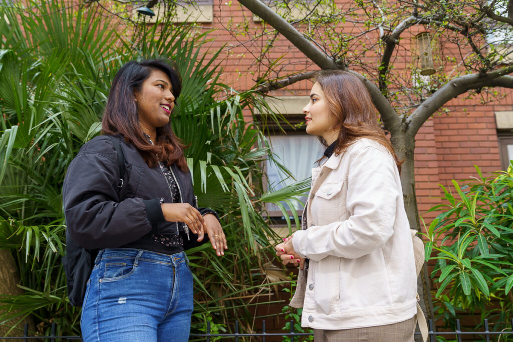 Two girls talking to each other 