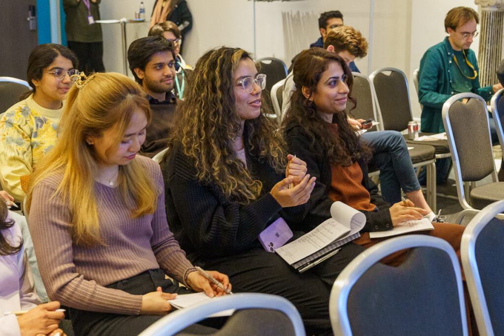 A group of people looking at a screen