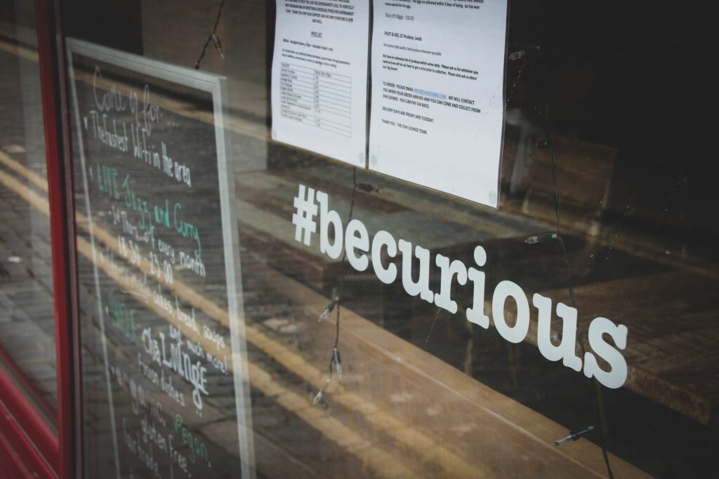 'Be curious' sign in the window