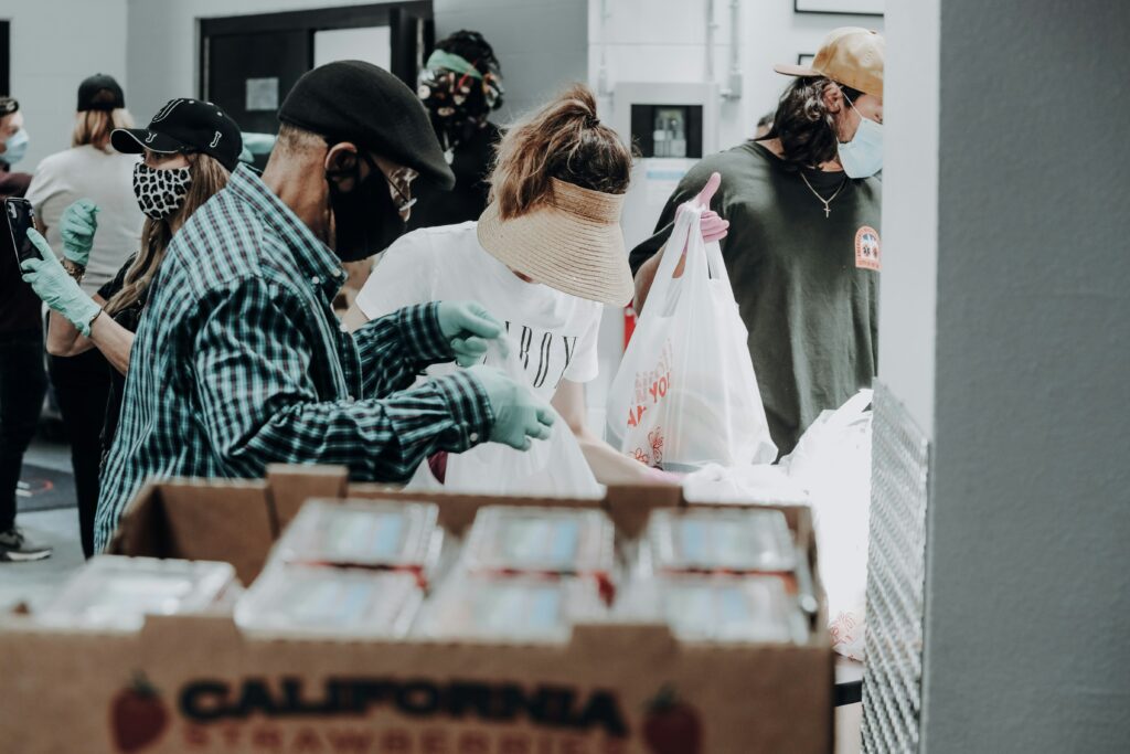 a few people packaging food to give to the homeless