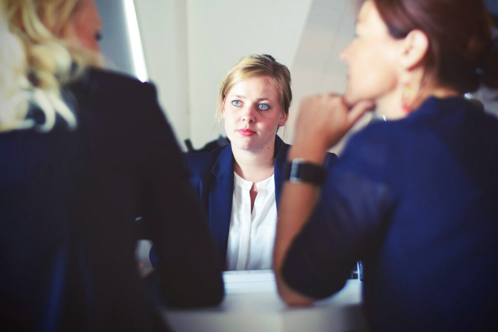 A women being interviewed by two people 