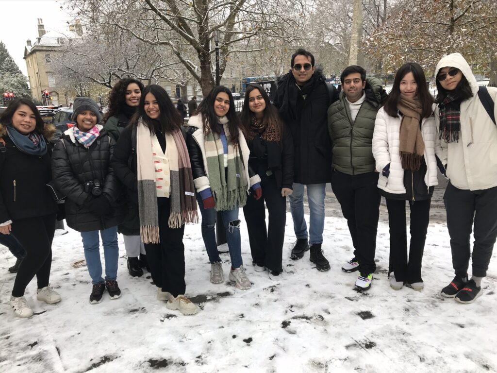 A group of people taking a photo is the snow 