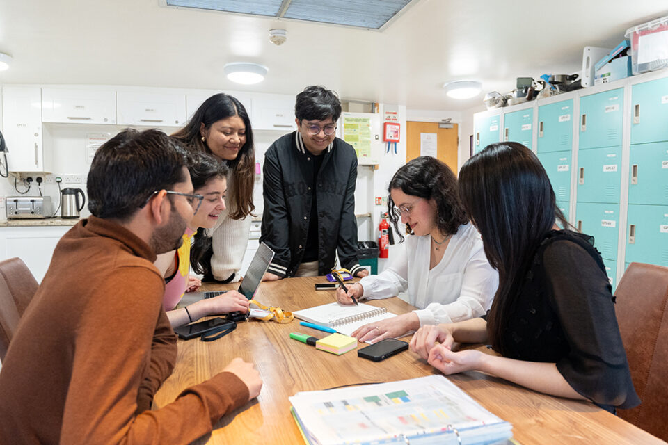 group of International Students in GPS Kitchen looking over their studies together