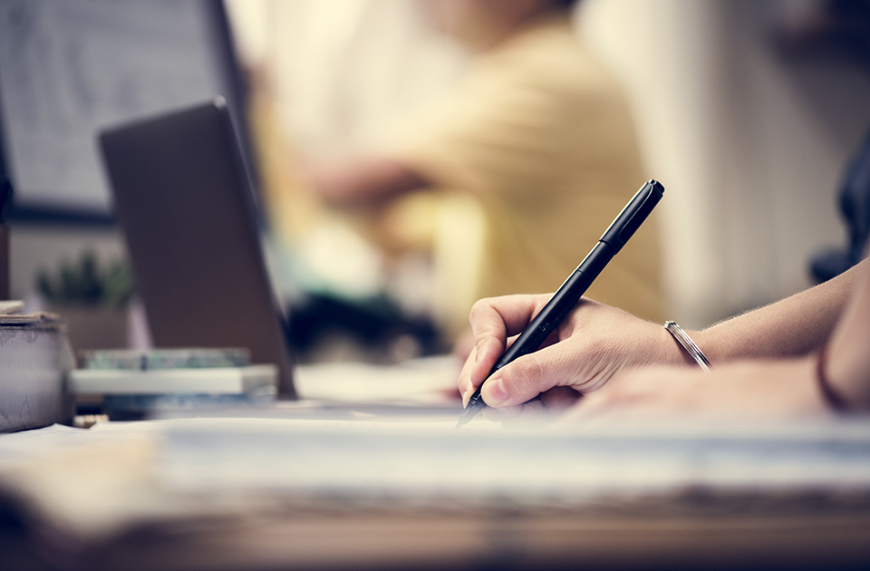 Close up of people's hand working on computer