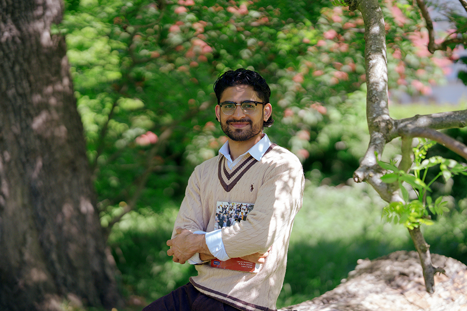 international student in the park with a book