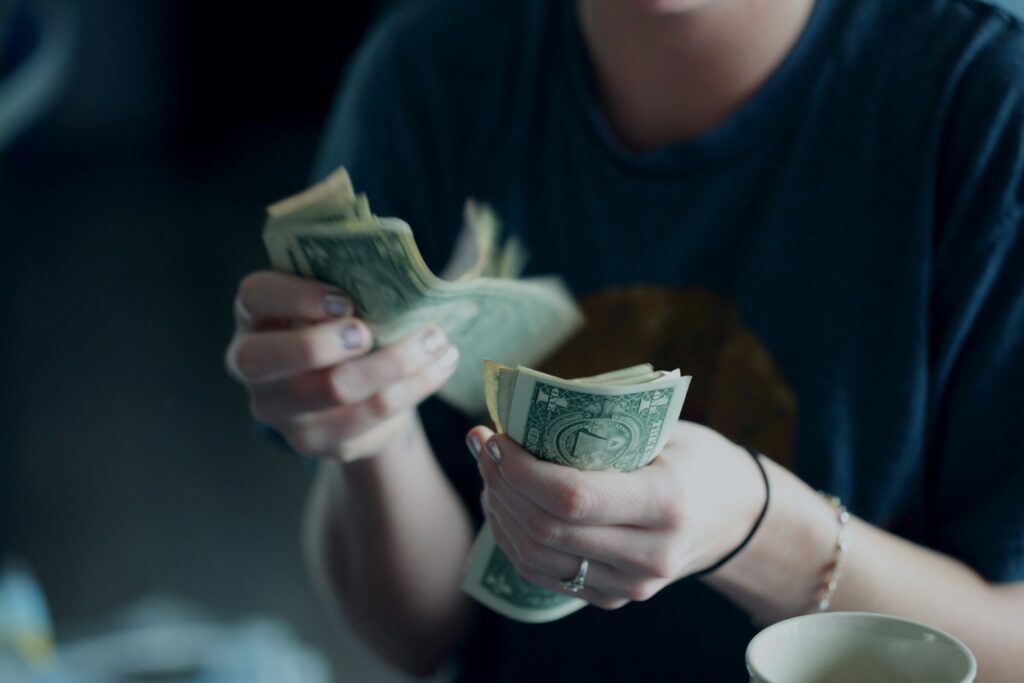 A person counting dollars 