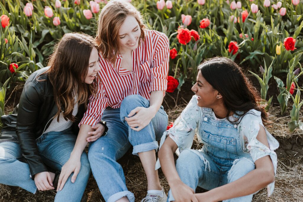 Three people laughing and talking to one another 