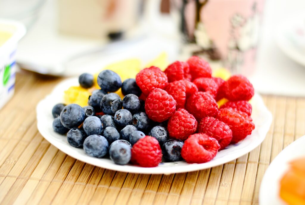 A plate of raspberries and blueberries 