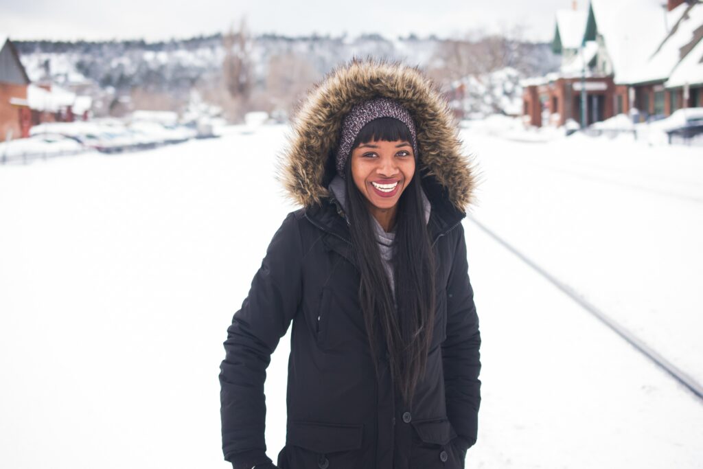 Woman wearing a coat in the snow 