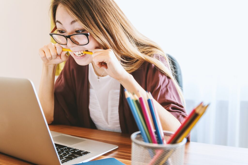 student who is biting a pencil indicating she is stressed