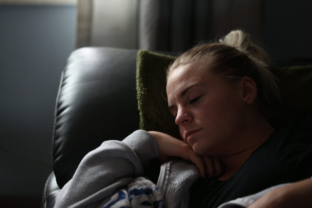 A woman sleeping oh her couch 