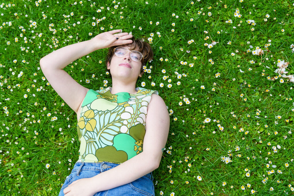 A girl laying down on the grass