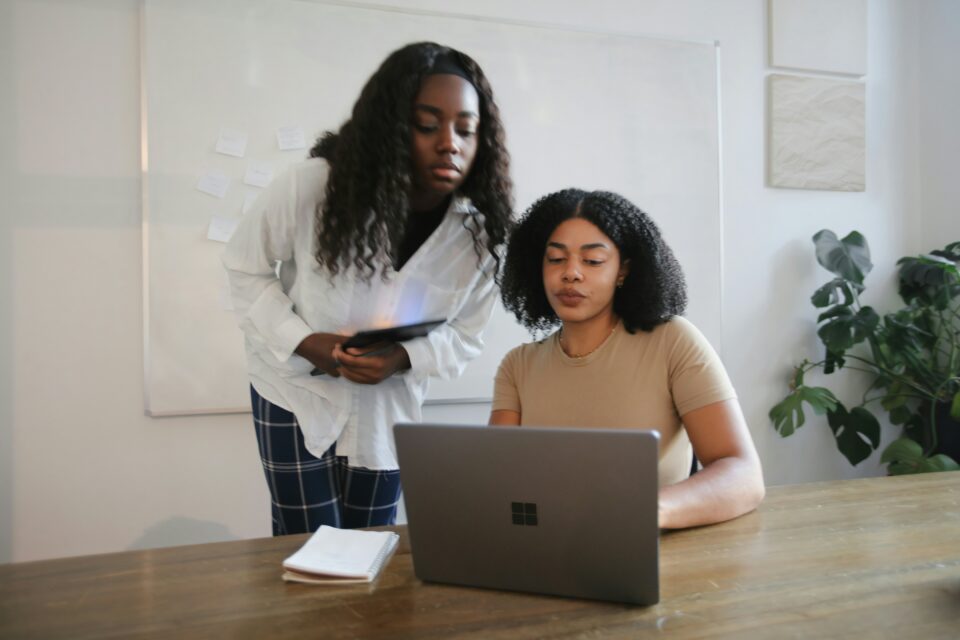 Two girls looking at a laptop