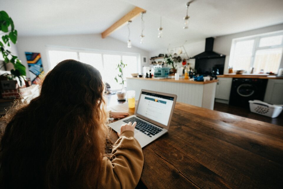 A girl scrolling through her laptop