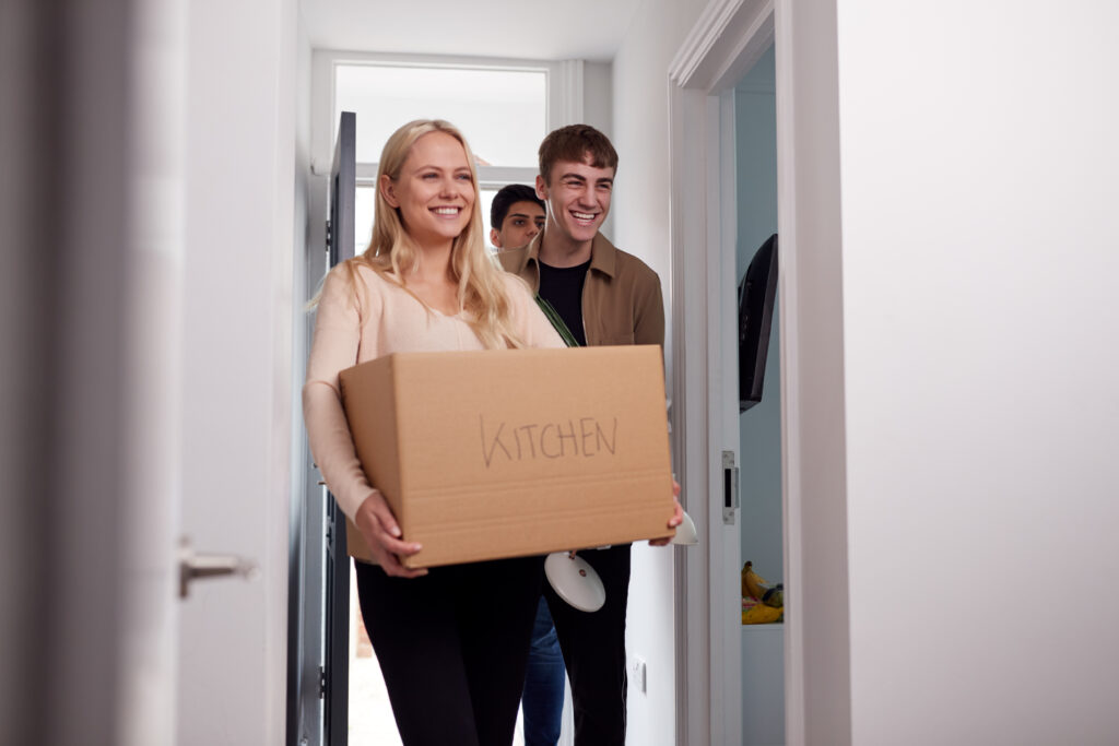 Group of university students moving into their accommodation.