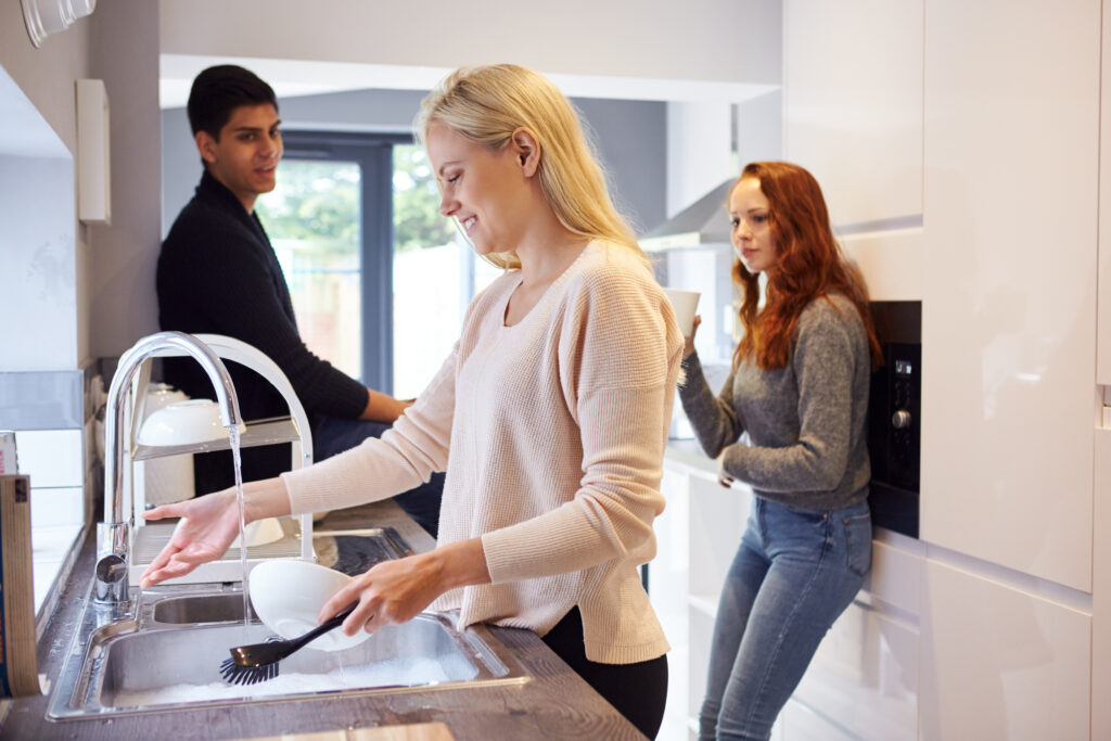 Group of roommates cleaning.