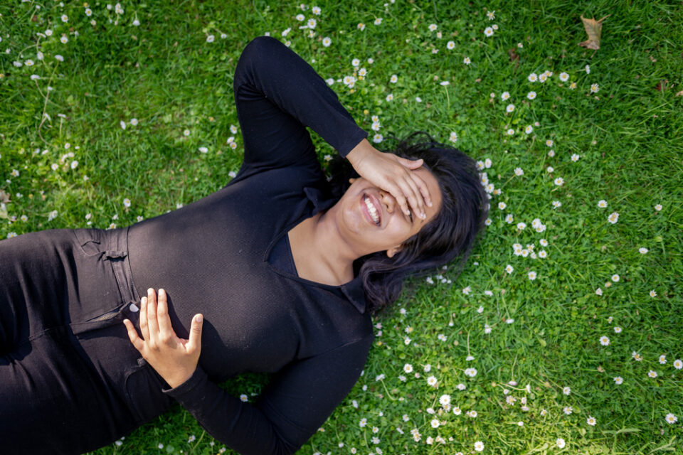 Student lying on grass