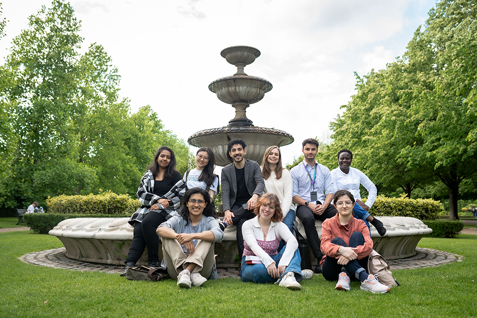 a group of international students who are ISH residents sitting at a fountain in Regents Park