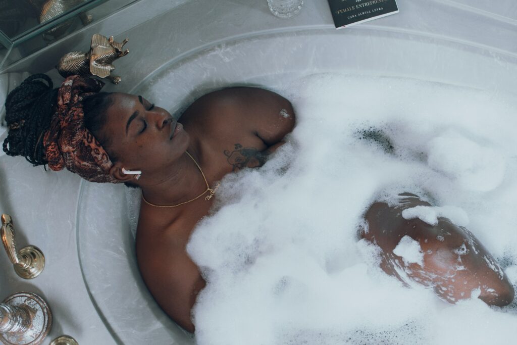 A woman taking a bath with her AirPods in