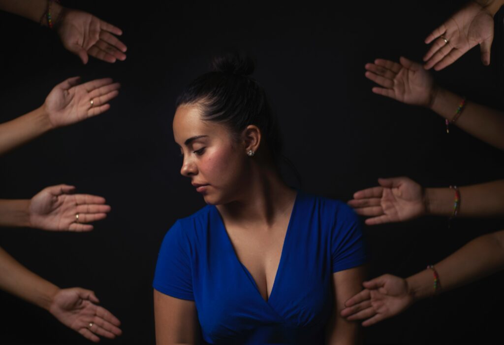 A woman turning away from hands 