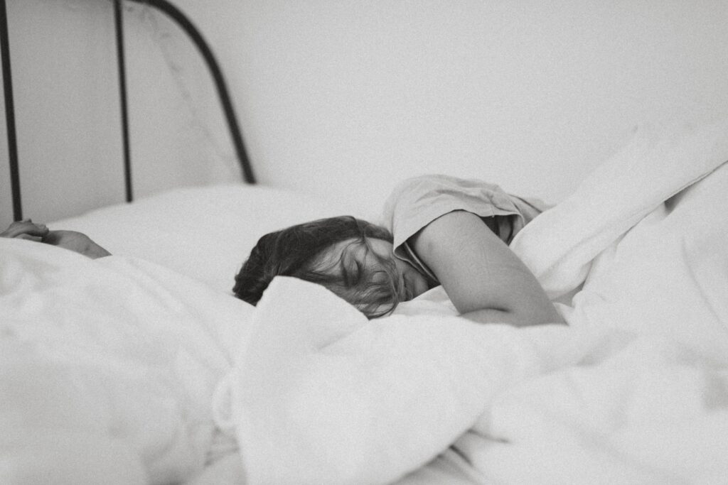 A woman sleeping on her bed