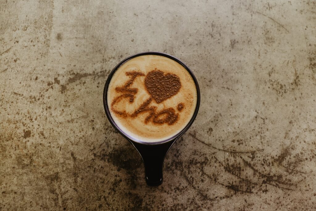 A cup of chai latte with the words on top of it