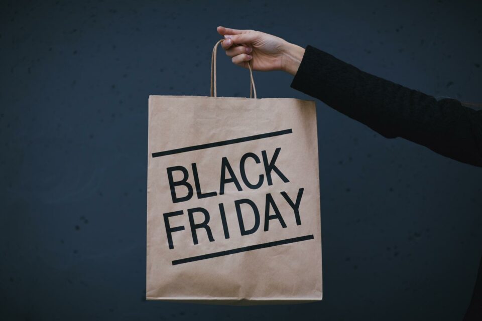 A picture with a person holding a Black Friday bag