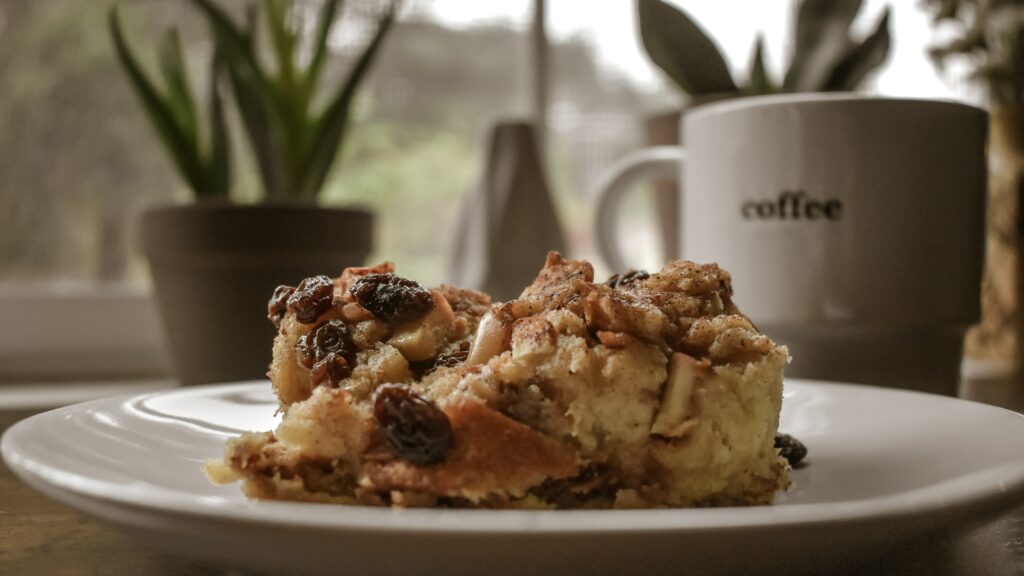 A picture with bread and butter pudding with a coffee on the side