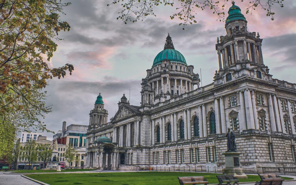 A picture of a building in Belfast with trees on the side of it 