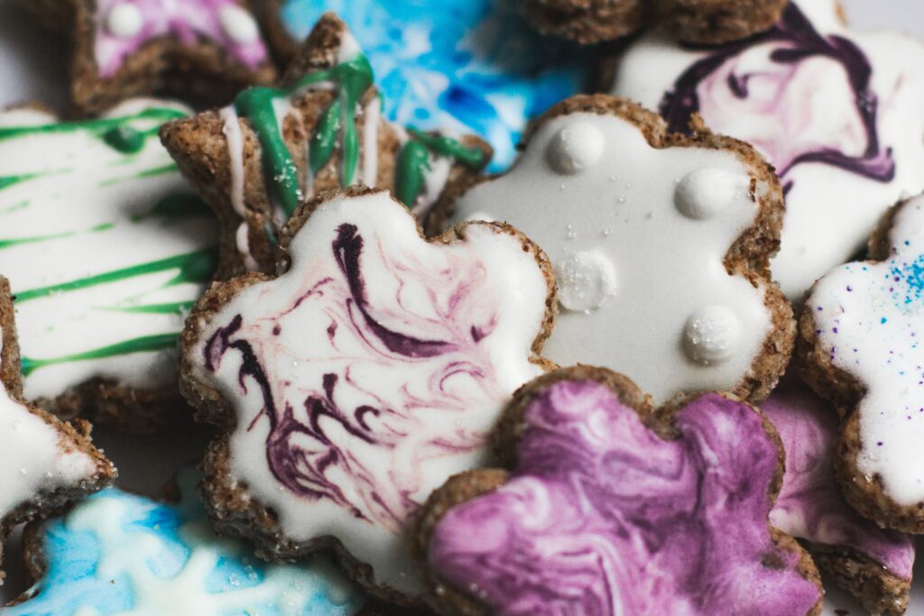 A picture of chocolate biscuits with colourful icing on it 