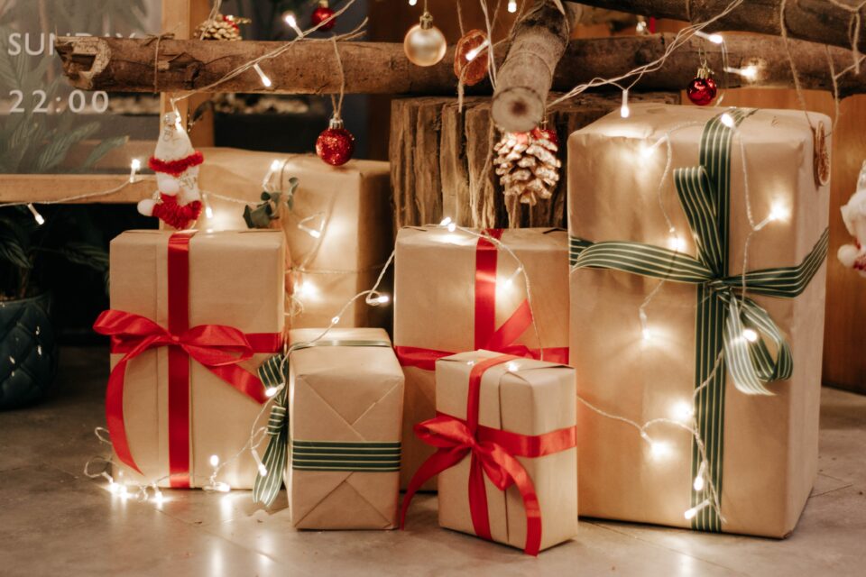 6 Christmas presents with fairy light wrapped around it