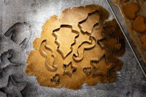 Different shapes of cookie cutters inside cookie dough