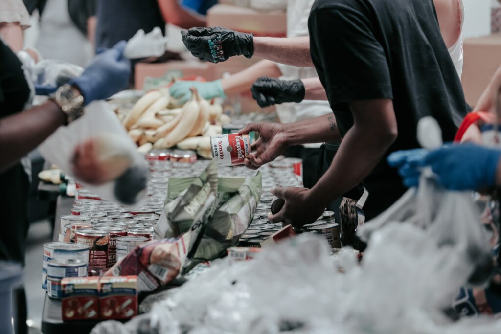 People giving food packages to people 