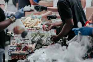 People giving food packages to people