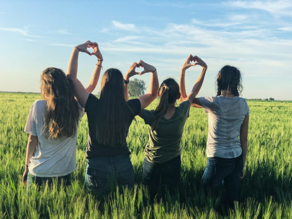 4 girls making hearts with their hands 