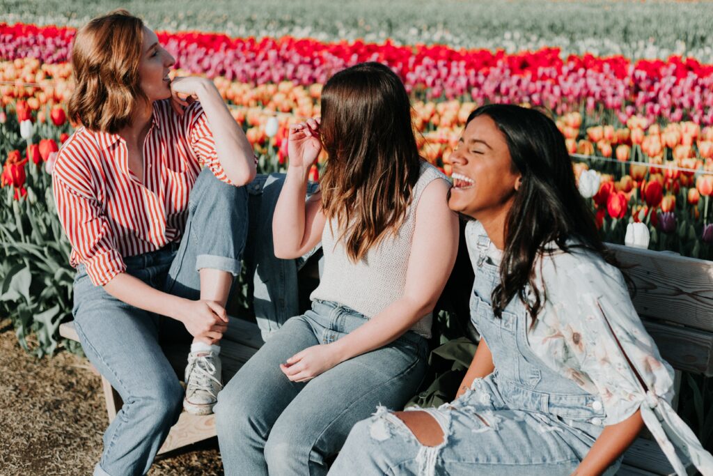 A group of friends laughing in a field