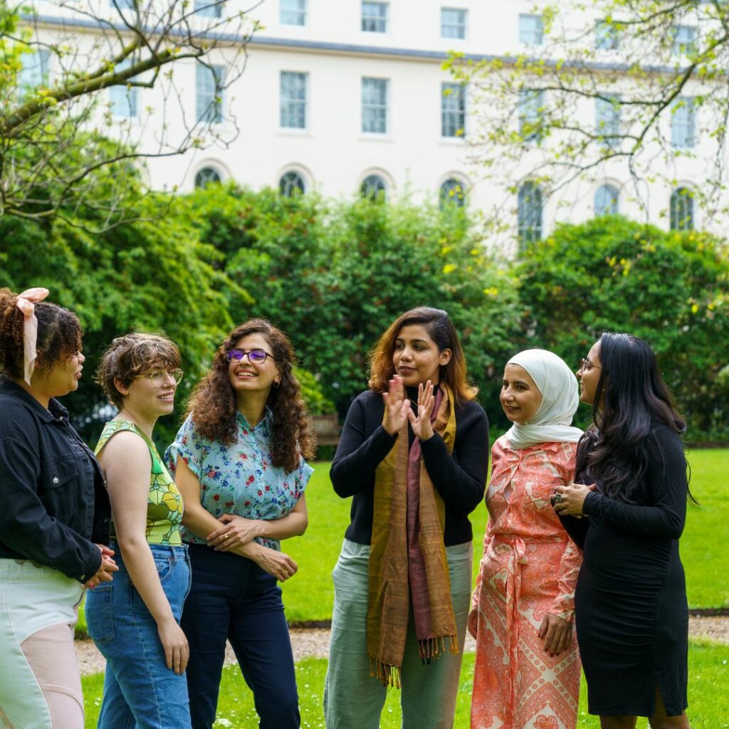 A group of people having conversations 