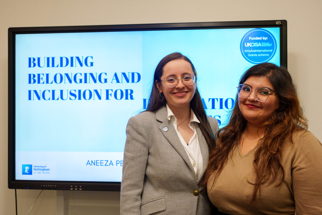 Aneeza and Diana in front of the screen