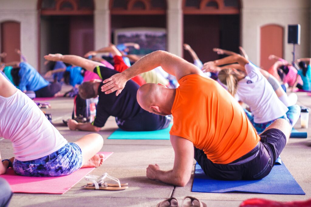 A bunch of people doing yoga on mats 