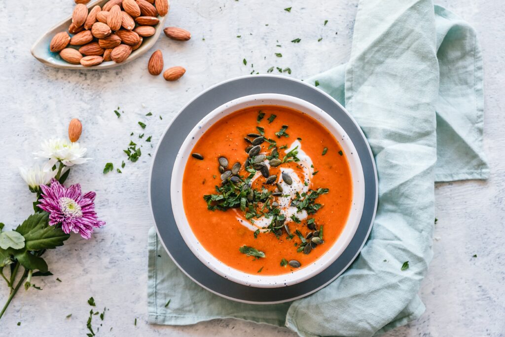 A picture of tomato soup with a green label cloth under it 