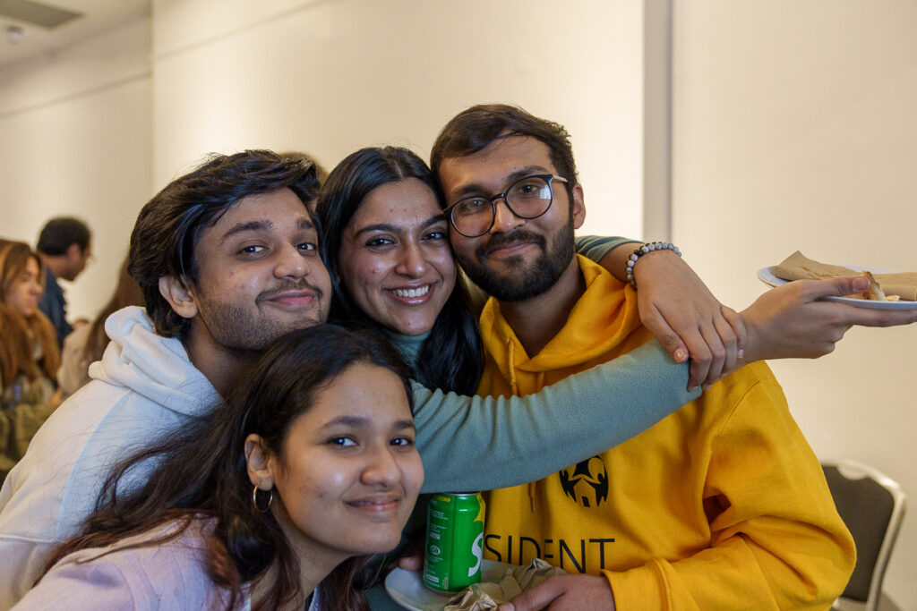 Four friends smiling at the camera 