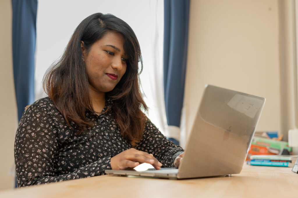 A girl typing on her laptop. 