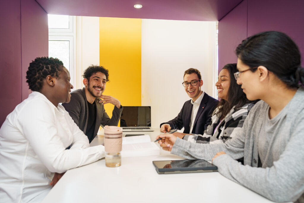 A group of people talking on a table