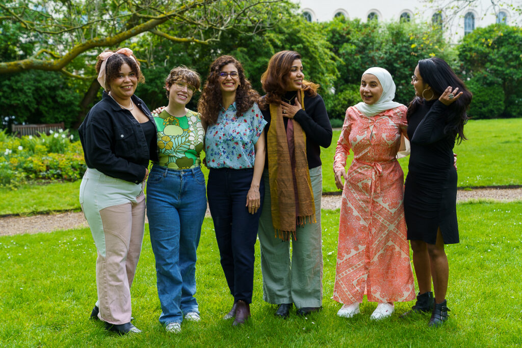 A group of women smiling for a photo.