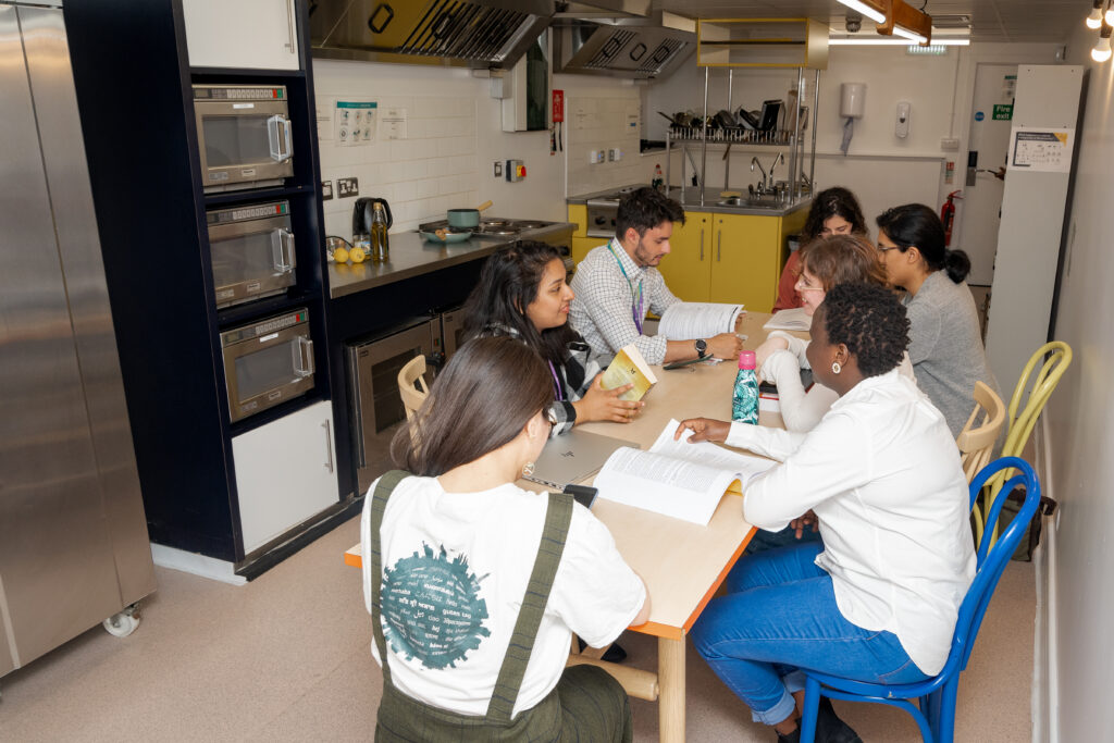 A group of students sat at the table in the kitchen 