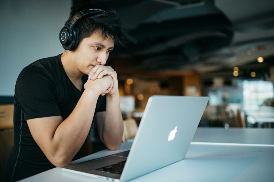 A man looking at his laptop stressed