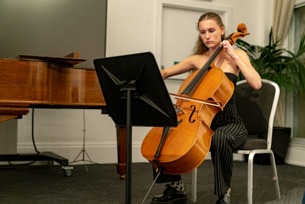 A woman playing her instrument 